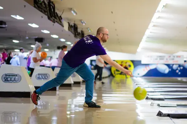 Man releasing a bowling ball