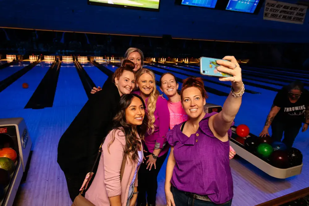Bowling team taking a selfie in front of their lane