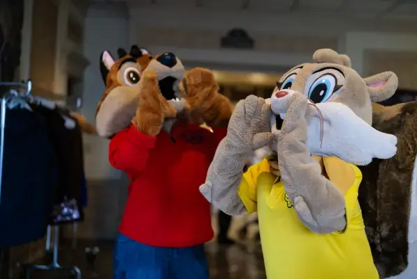 Two wolf mascots howling